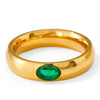 Gold ring with a green gemstone on a white background